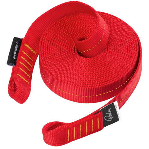 A red rolled up webbing sling showing sewn loops at each end and manufacturers logos on a white background.