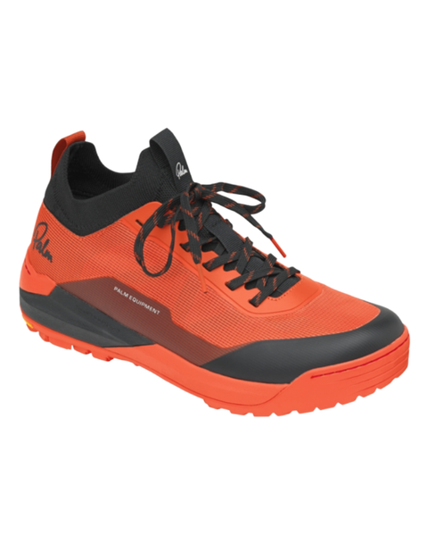 An orange shoe with black lining and laces with Palm Equipment lettering.