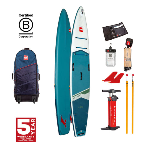 A Red Paddle Co paddleboard set with accessories including a backpack, paddle, and carry handle. The board is blue with a red logo and the text '5 Year Warranty' on it.