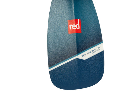 Close up picture showing the blade of a paddleboard paddle. Blue paddle with Red logo on a white background. 