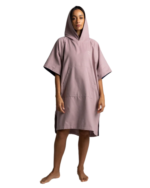 Person wearing a pink hooded towel on a white background