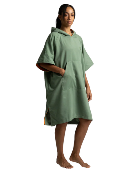 Person wearing a green hooded towel on a white background