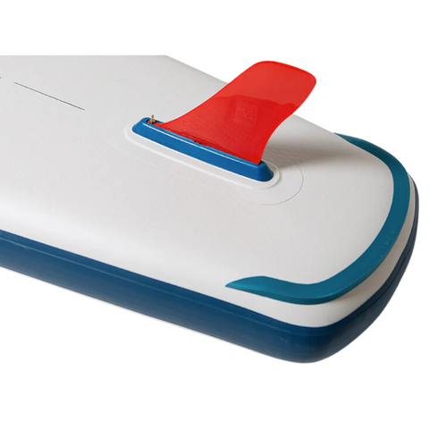 The tail section of a paddleboard with a fitted red fin. The board is white with blue trim.