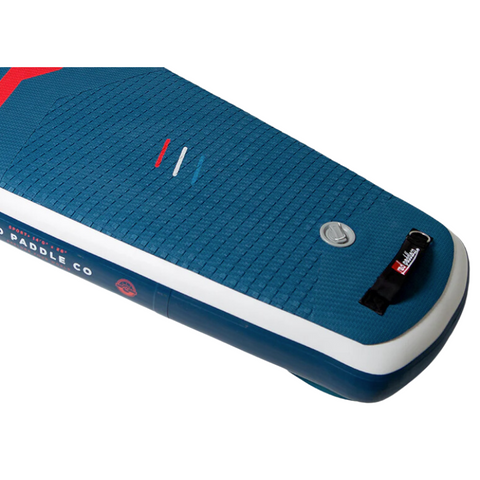 The tail section of an inflated paddleboard. Red, white and blue with brand details, carry handle and grey valve. 