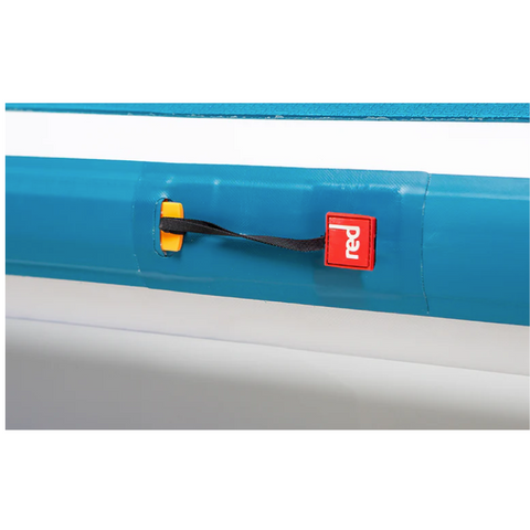 Close up image of the side of a paddleboard showing brand logo in red and white