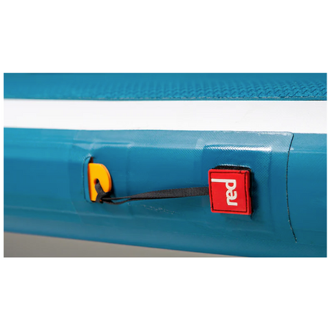 Close up image of the side of a blue paddleboard with brand logo in red and white.