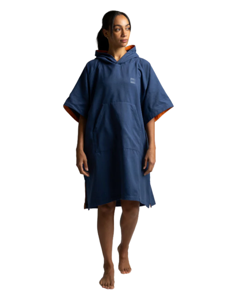 Person wearing a blue and orange micro fibre poncho on a white background