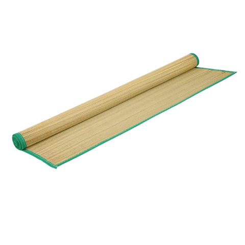 A partially rolled up straw beach mat with green trim edging.