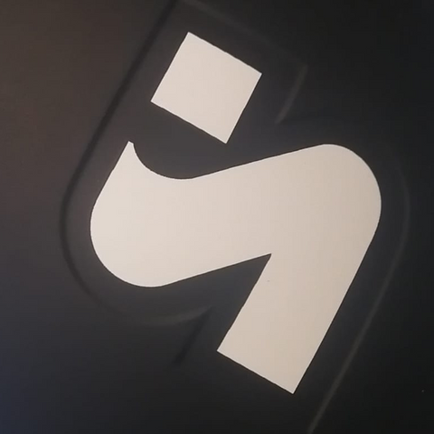 Black and white logo in the shape of the letter S