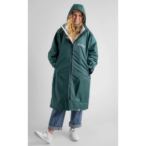 Person wearing a dark green dryrobe with long sleeves and a hood.